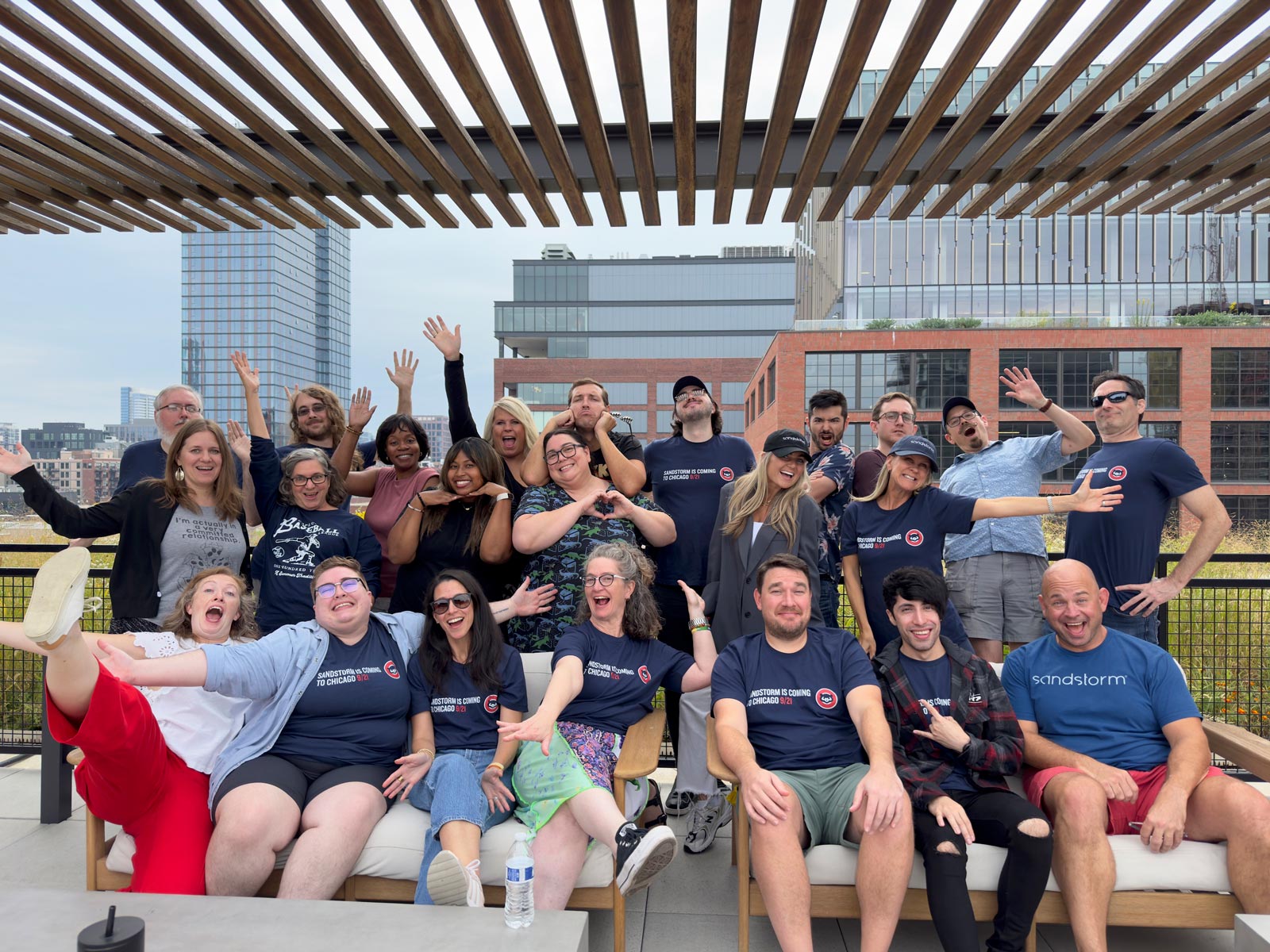 Sandstorm team in a fun pose on the rooftop at Chief