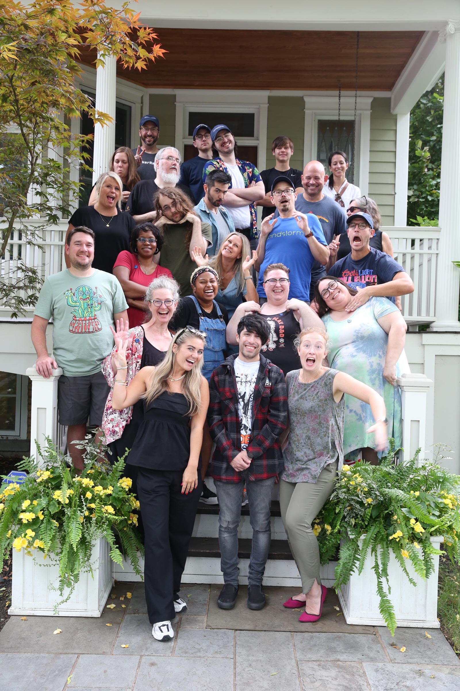 Sandstorm team in a fun pose on the stairs of the Marsico house