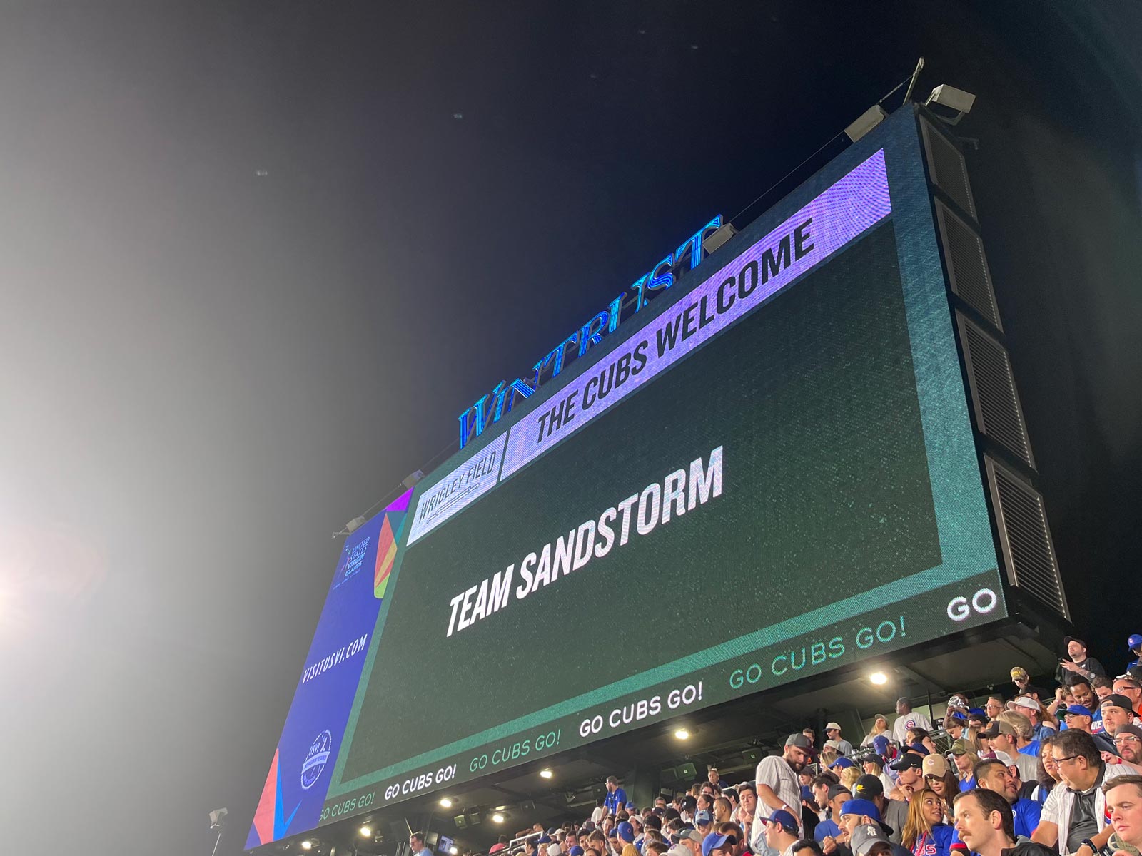 The Cubs Welcome Team Sandstorm displayed on the score board at Wrigley