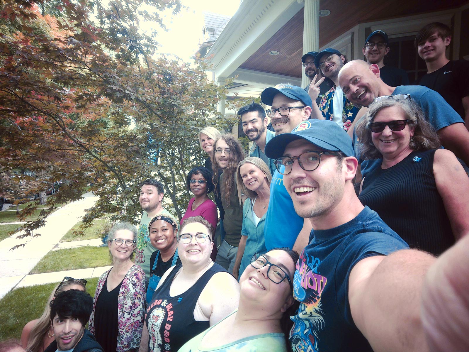 Nathan holds the camera for a Sandstorm group selfie on the stairs at Sandy's house