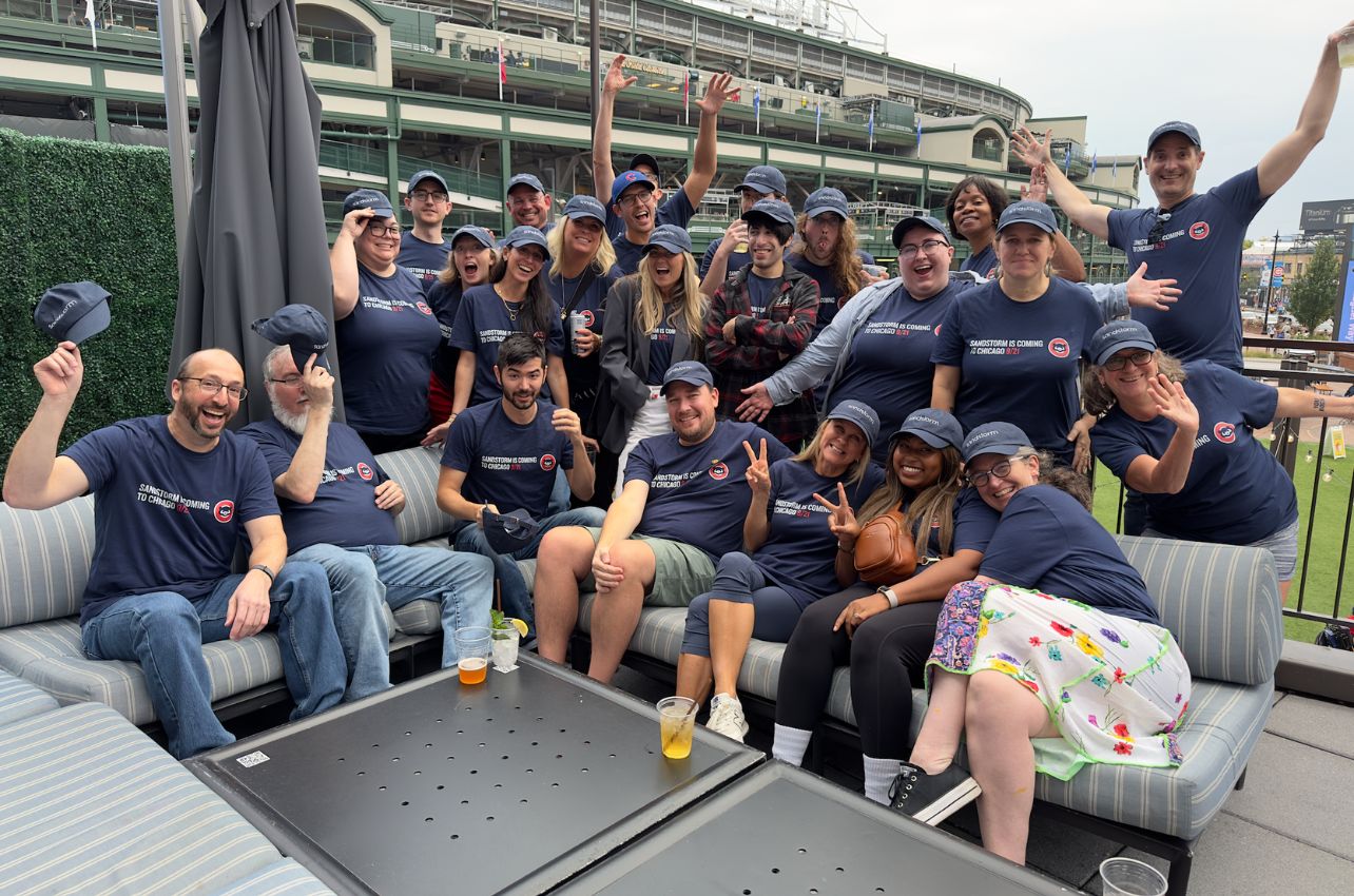 The Sandstorm team poses excitedly outside of Wrigley Field.