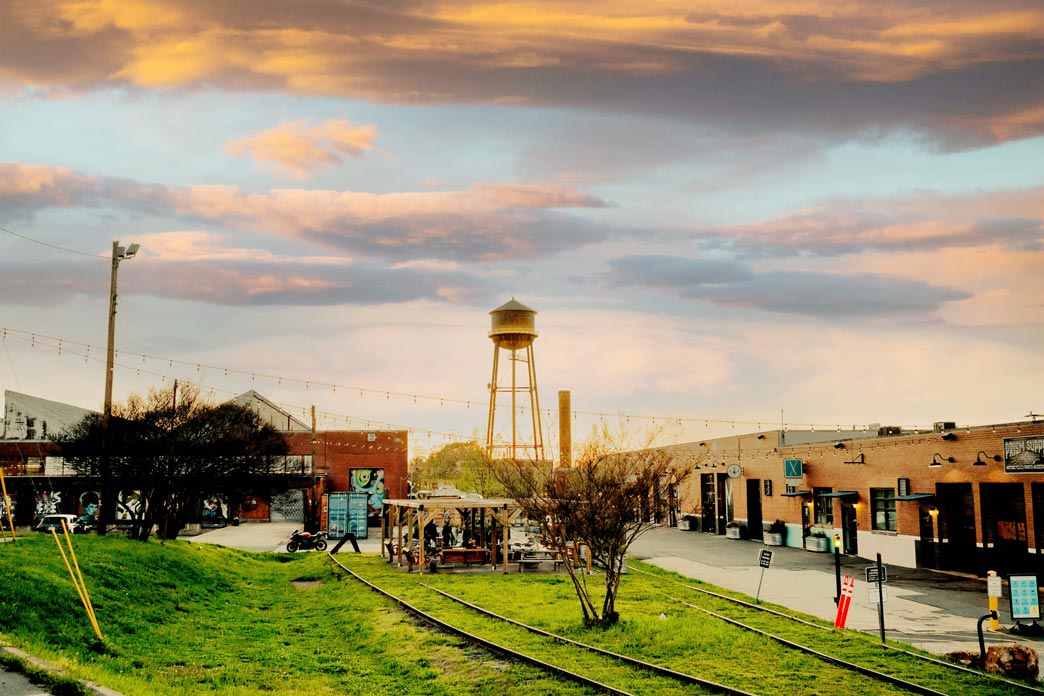 A town in the foreground with a water tower in the background