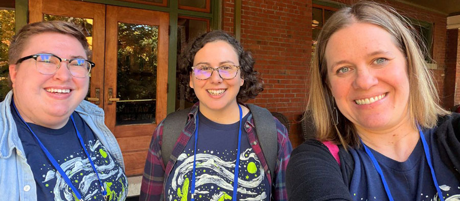 Syd, Madeline, and Emily smile at the camera from PNW Drupal Summit 2025