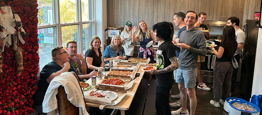 Sandstormers enjoying Lou Malnati's pizza at the 2025 Summit