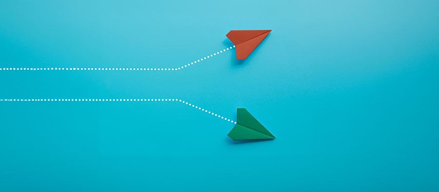 Red and green paper planes on blue background