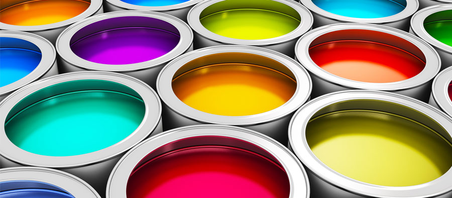A closeup of several different cans of paint, each a different vibrant color.