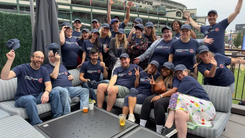 The Sandstorm team poses excitedly outside of Wrigley Field.