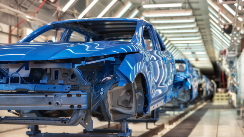 Multiple cars being built on a factory line