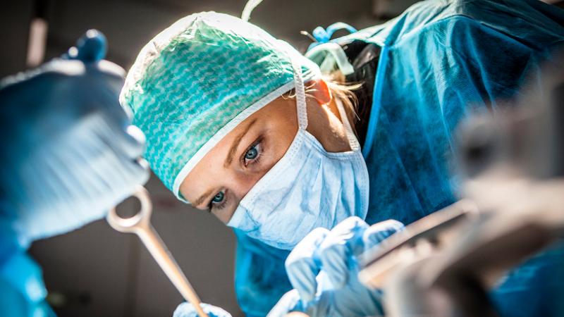 Close-up of female surgeon operating
