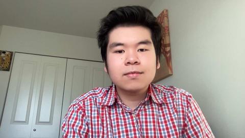 Alex Dinh a light skinned male with black hair wearing a read and blue button down shirt