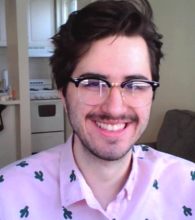 man wearing glasses and pink shirt