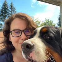 Madeline smiling with her dog, Kuma