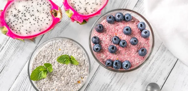 Two bowls of chia pudding with blueberries and pitaya