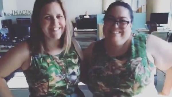 Emily and Alma wearing matching dinosaur dresses